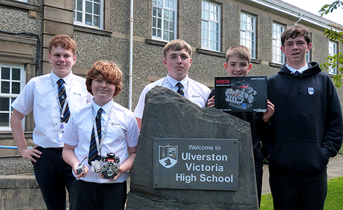 Studrnts sdat around the UVHS slate entrance obelisk