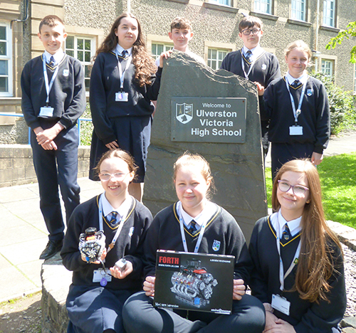 Studrnts sdat around the UVHS slate entrance obelisk